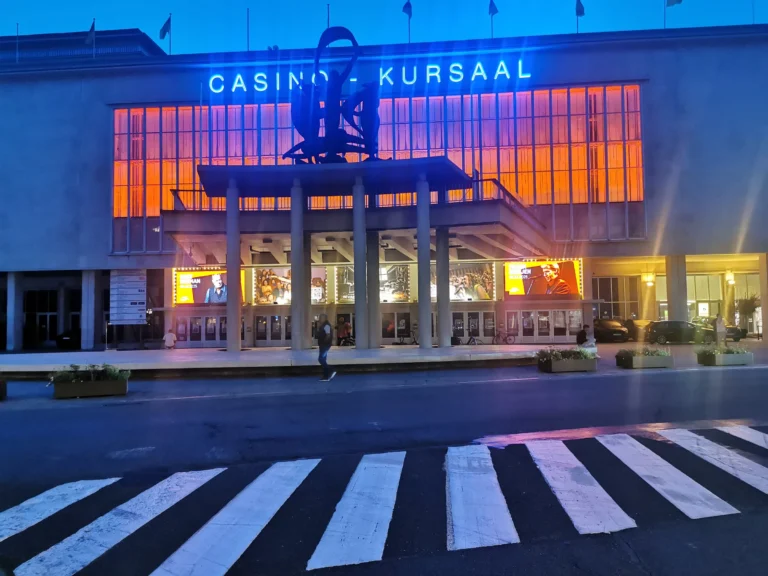 The Casino-Kursaal at dusk, a minute's walk from La Bohème, with its orange-lit windows and blue neon sign above the entrance