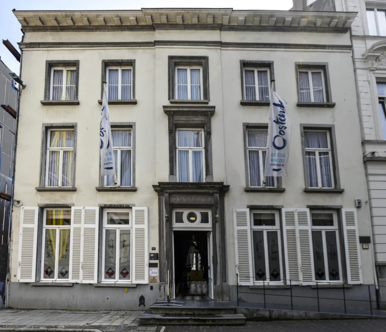 Cream neoclassical façade of the City Museum on Langestraat, the former royal residence, with shuttered windows