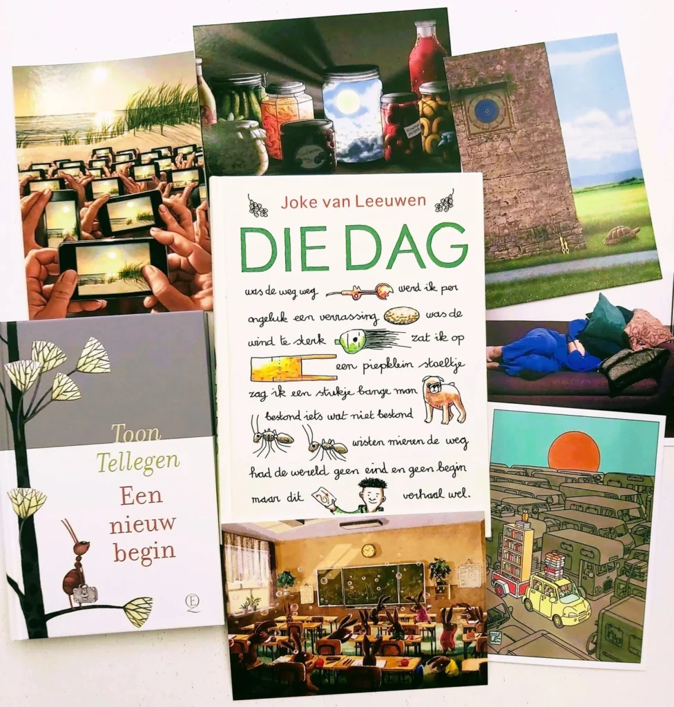 Flat lay of Dutch children's and picture books with a spread of illustrated postcards around them