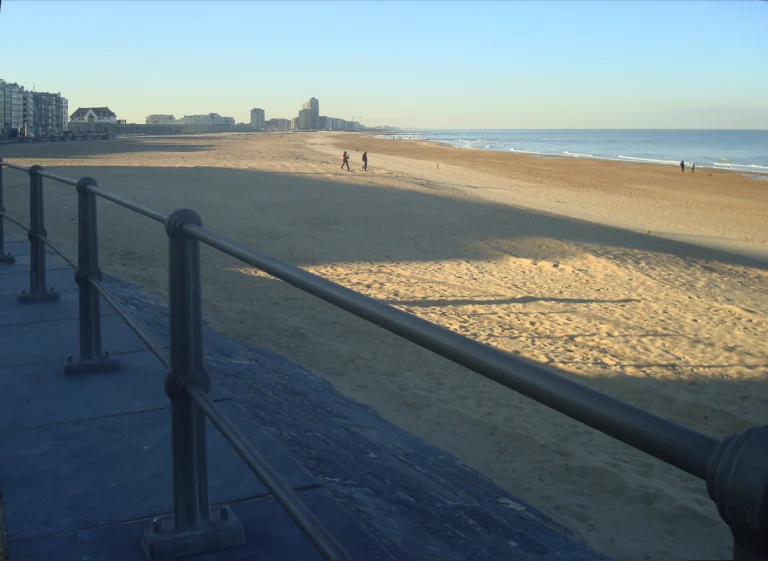 The wide Groot Strand beside the Kursaal on a bright, cold February day, with a few walkers