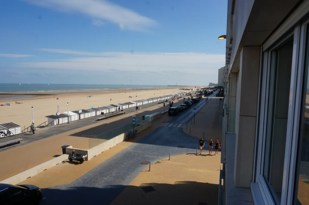 The wide North Sea beach and sea wall at Ostend under a bright sky