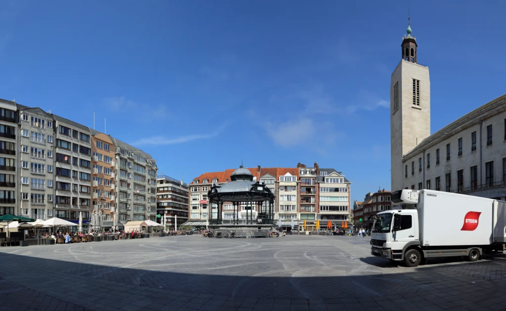 The Wapenplein, Ostend's central square, lined with town houses and cafes under a bright sky