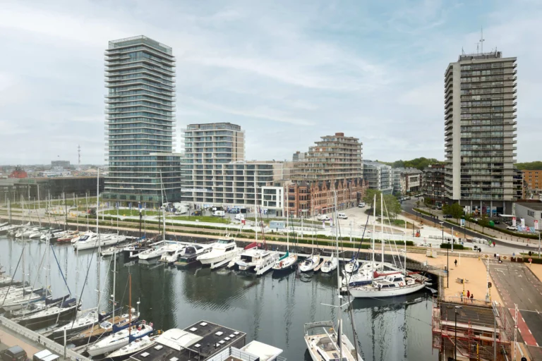 View from a hotel room over the Ostend marina, with moored yachts and modern apartment towers behind