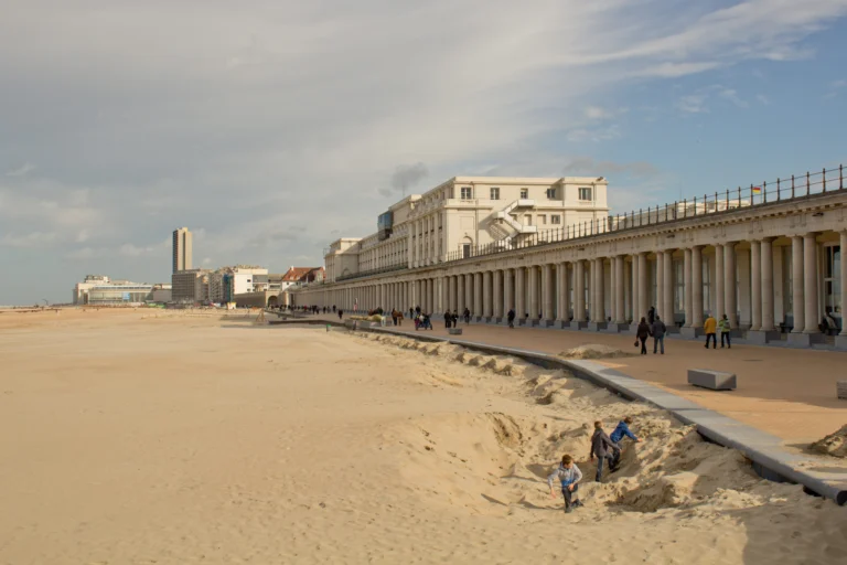 Long stone colonnade of the Royal Galleries along the seafront, seen from the sandy beach