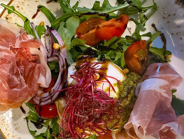 Burrata with pesto, roasted cherry tomatoes, rocket and Parma ham