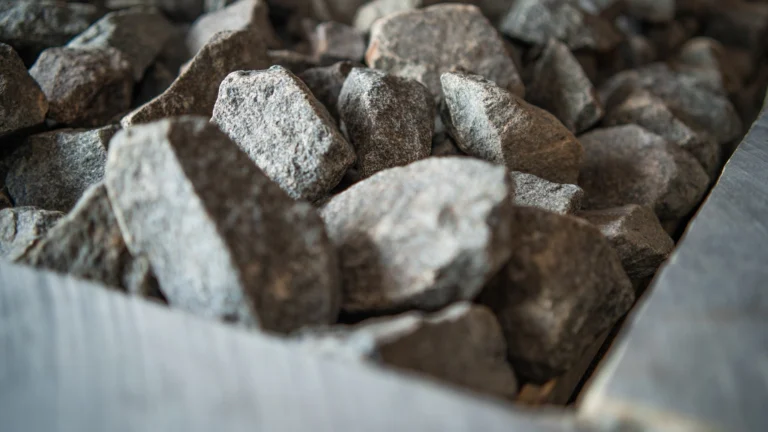 Close-up of grey sauna stones piled in a heater